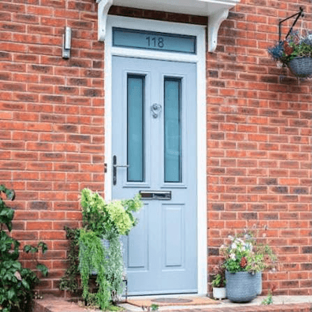 Light blue composite front door on a red brick house