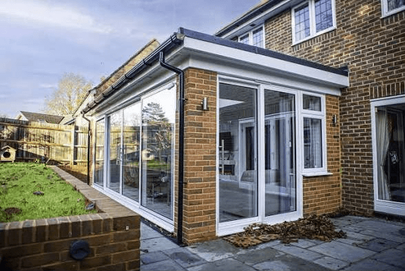 Single storey home extension with large glass windows and doors on a brick house